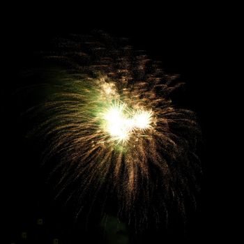 Colorful celebration fireworks isolated on a black sky background.