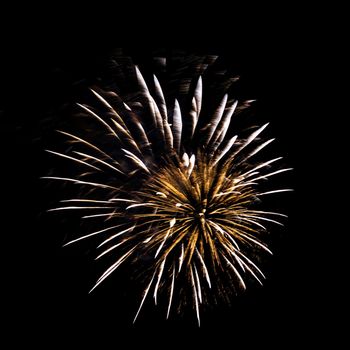 Colorful celebration fireworks isolated on a black sky background.