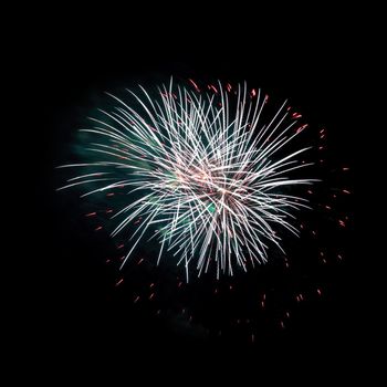 Colorful celebration fireworks isolated on a black sky background.