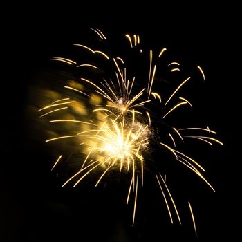 Colorful celebration fireworks isolated on a black sky background.