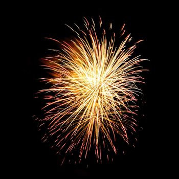 Colorful celebration fireworks isolated on a black sky background.