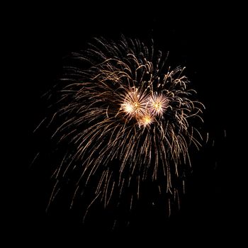 Colorful celebration fireworks isolated on a black sky background.