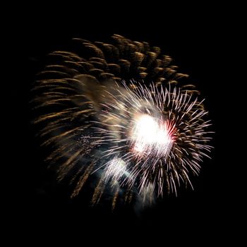 Colorful celebration fireworks isolated on a black sky background.