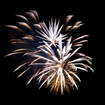 Colorful celebration fireworks isolated on a black sky background.