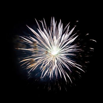 Colorful celebration fireworks isolated on a black sky background.