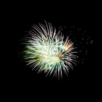 Colorful celebration fireworks isolated on a black sky background.