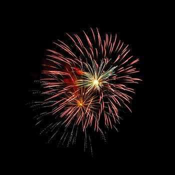 Colorful celebration fireworks isolated on a black sky background.