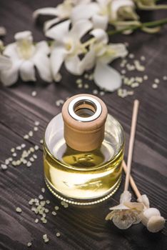 Spa decoration. Bottle of essential oil and orchid flowers.