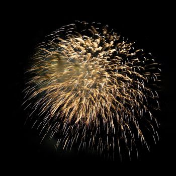 Colorful celebration fireworks isolated on a black sky background.