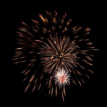 Colorful celebration fireworks isolated on a black sky background.