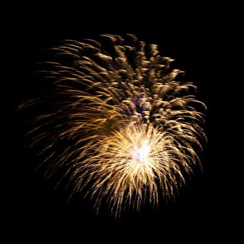 Colorful celebration fireworks isolated on a black sky background.