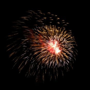 Colorful celebration fireworks isolated on a black sky background.