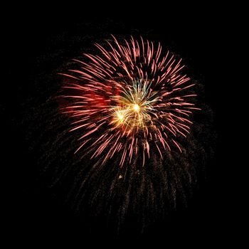 Colorful celebration fireworks isolated on a black sky background.