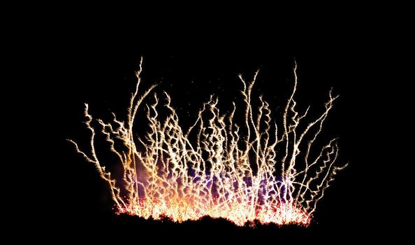 Colorful celebration fireworks isolated on a black sky background.