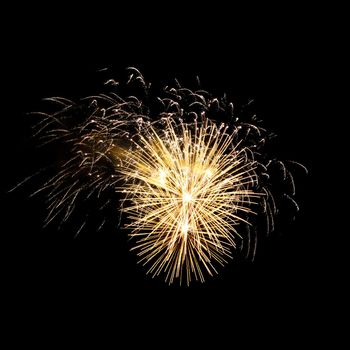 Colorful celebration fireworks isolated on a black sky background.