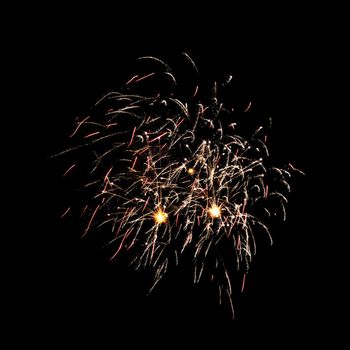 Colorful celebration fireworks isolated on a black sky background.