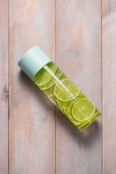 Detox Infused Water with Lime and Mint in Sports Bottle, with slices of lime.