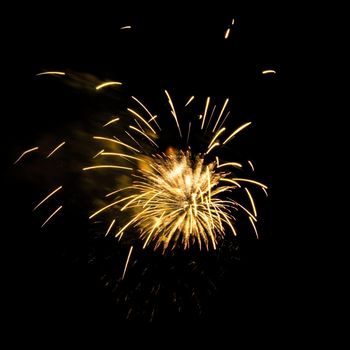 Colorful celebration fireworks isolated on a black sky background.