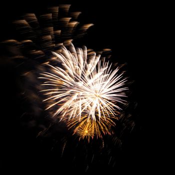 Colorful celebration fireworks isolated on a black sky background.