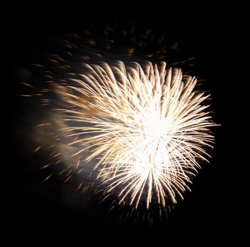 Colorful celebration fireworks isolated on a black sky background.