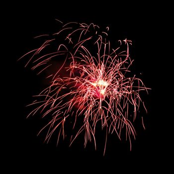 Colorful celebration fireworks isolated on a black sky background.