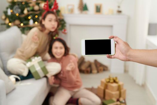 attractive girlfriends exchanging gifts at home on christmas eve.