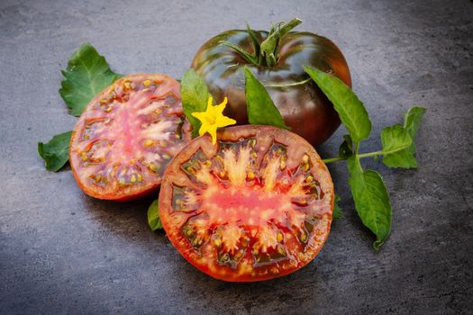 Crimea black tomato, Solanum lycopersicum over dark background