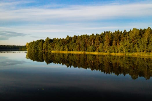 Top view of Bolta lake in the forest in the Braslav lakes National Park at dawn, the most beautiful places in Belarus.An island in the lake.Belarus