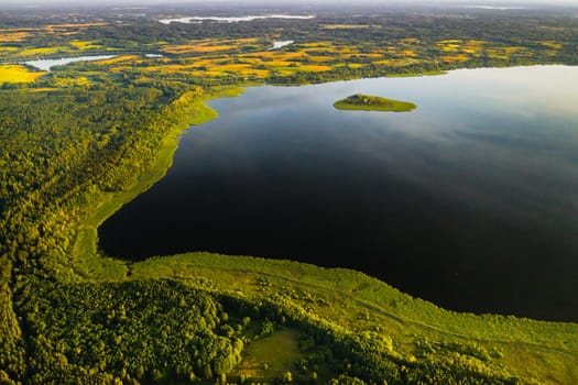 Top view of lake Drivyaty in the forest in the Braslav lakes National Park at sunset, the most beautiful places in the city of Belarus.An island in the lake.Belarus