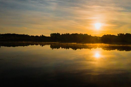 Top view of lake Drivyaty in the forest in the Braslav lakes National Park at sunset, the most beautiful places in the city of Belarus.An island in the lake.Belarus