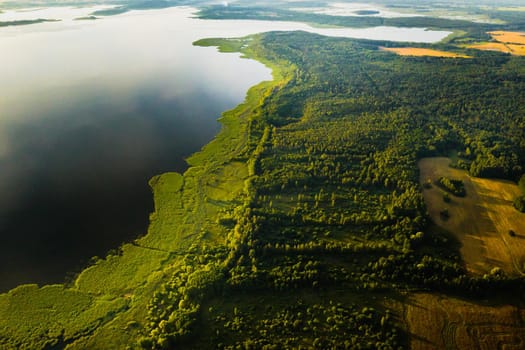 Top view of lake Drivyaty in the forest in the Braslav lakes National Park at sunset, the most beautiful places in the city of Belarus.An island in the lake.Belarus