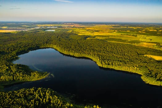 Top view of Bolta lake in the forest in the Braslav lakes National Park at dawn, the most beautiful places in Belarus.An island in the lake.Belarus