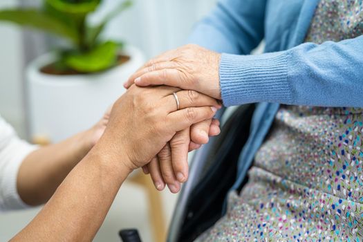 Holding hands Asian senior or elderly old lady woman patient with love, care, encourage and empathy at nursing hospital ward, healthy strong medical concept