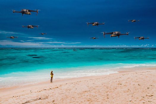 Drones fly over the beach of a tropical island in the Indian Ocean. A natural landscape with drones flying over it. quadrocopter.