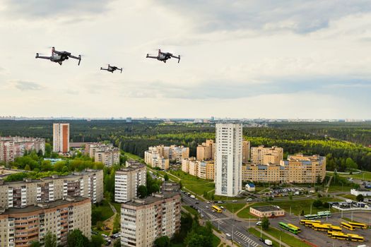 Drones flying over the houses of the city of Minsk. Urban landscape with drones flying over it.Quadrocopters fly over the city