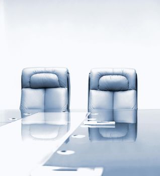 conference room with wooden table and beige leather armchairs