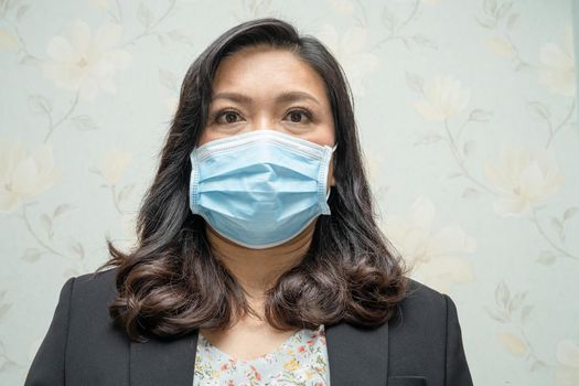 Asian lady wearing mask new normal in office for protect safety infection Covid-19 Coronavirus.