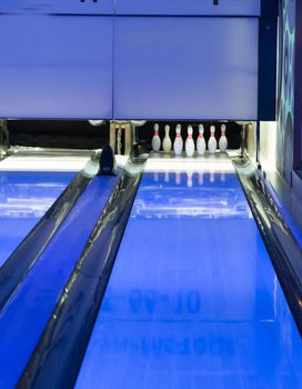 empty bowling hall with blue neon light