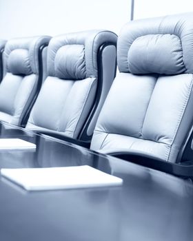 Closeup of on table in empty corporate conference room before business meeting in office