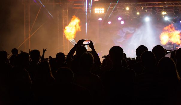 silhouettes of crowd at concert on music festival