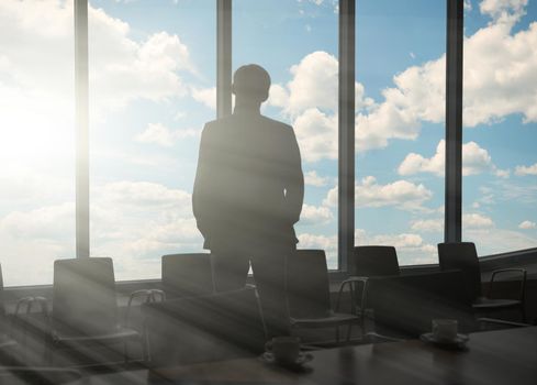 Side view of a businessman looking through window