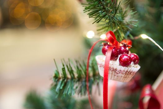 Christmas tree decoration with cupcake dessert and ribbon