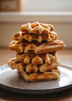 a few Belgian waffles on a plate in a cafe