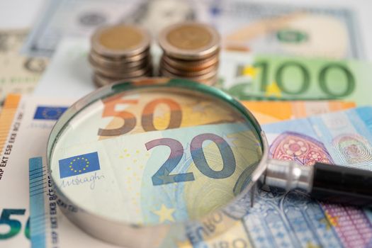Magnifying glass and Euro banknotes background, Banking Account, Investment Analytic research data economy, trading, Business company concept.