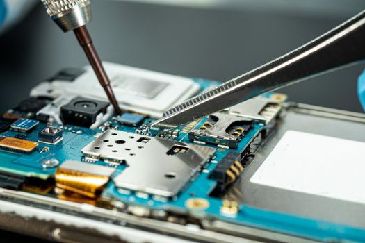 technician repairing inside of hard disk by soldering iron. Integrated Circuit. the concept of data, hardware, technician and technology.