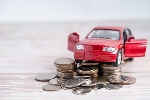 Car on stack of coins. Car loan, Finance, saving money, insurance and leasing time concepts.