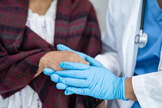 Doctor holding touching hands Asian senior or elderly old lady woman patient with love, care, helping, encourage and empathy at nursing hospital ward, healthy strong medical concept