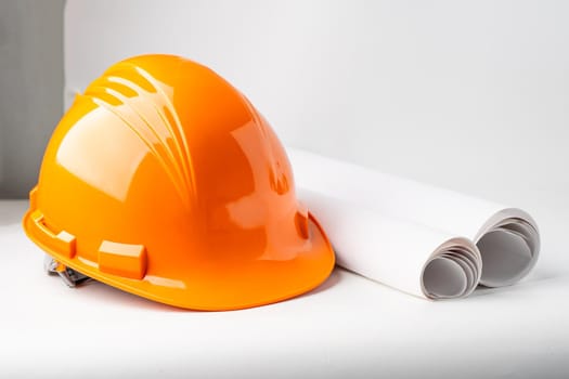 Orange construction helmet isolated on white background, engineer concept.