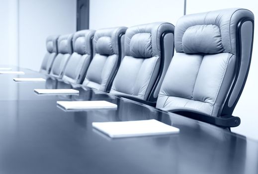 Closeup of on table in empty corporate conference room before business meeting in office