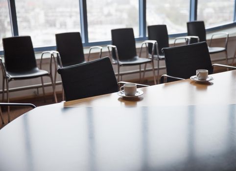 Meeting room with coffee cups before meeting